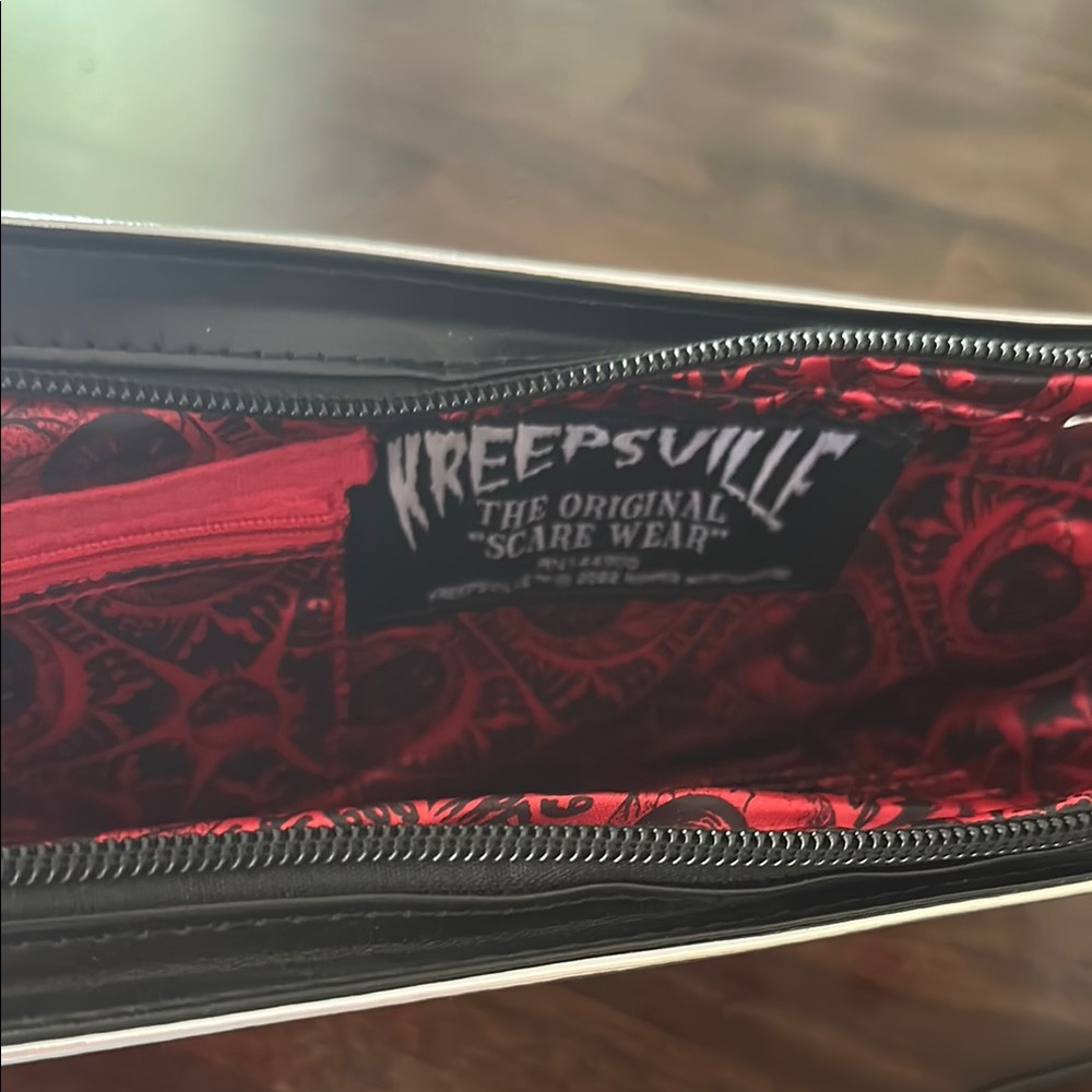 LAST CHANCE OFFER:
Kreepsville Cleaver Red and metallic Wristlet Clutch - Picture 2 of 3